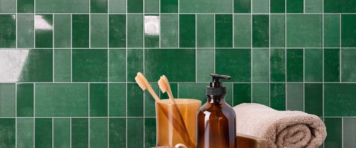 Bamboo brushes in dark glass, bottle of liquid soap, wooden ear sticks, reusable cotton pads. Eco bathroom interior. Zero waste concept