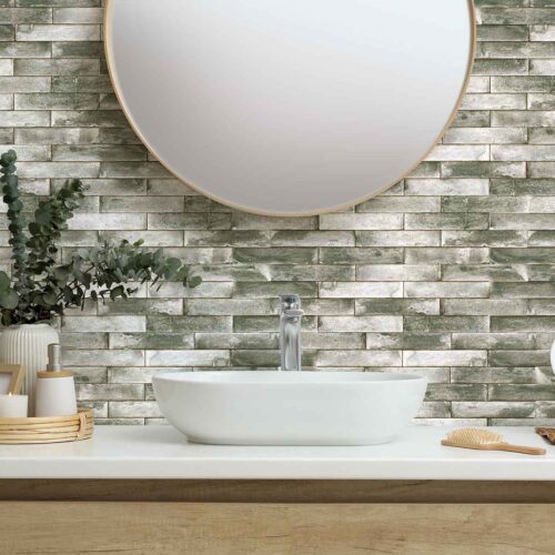 Stylish mirror, eucalyptus branches and vessel sink in modern bathroom. Interior design